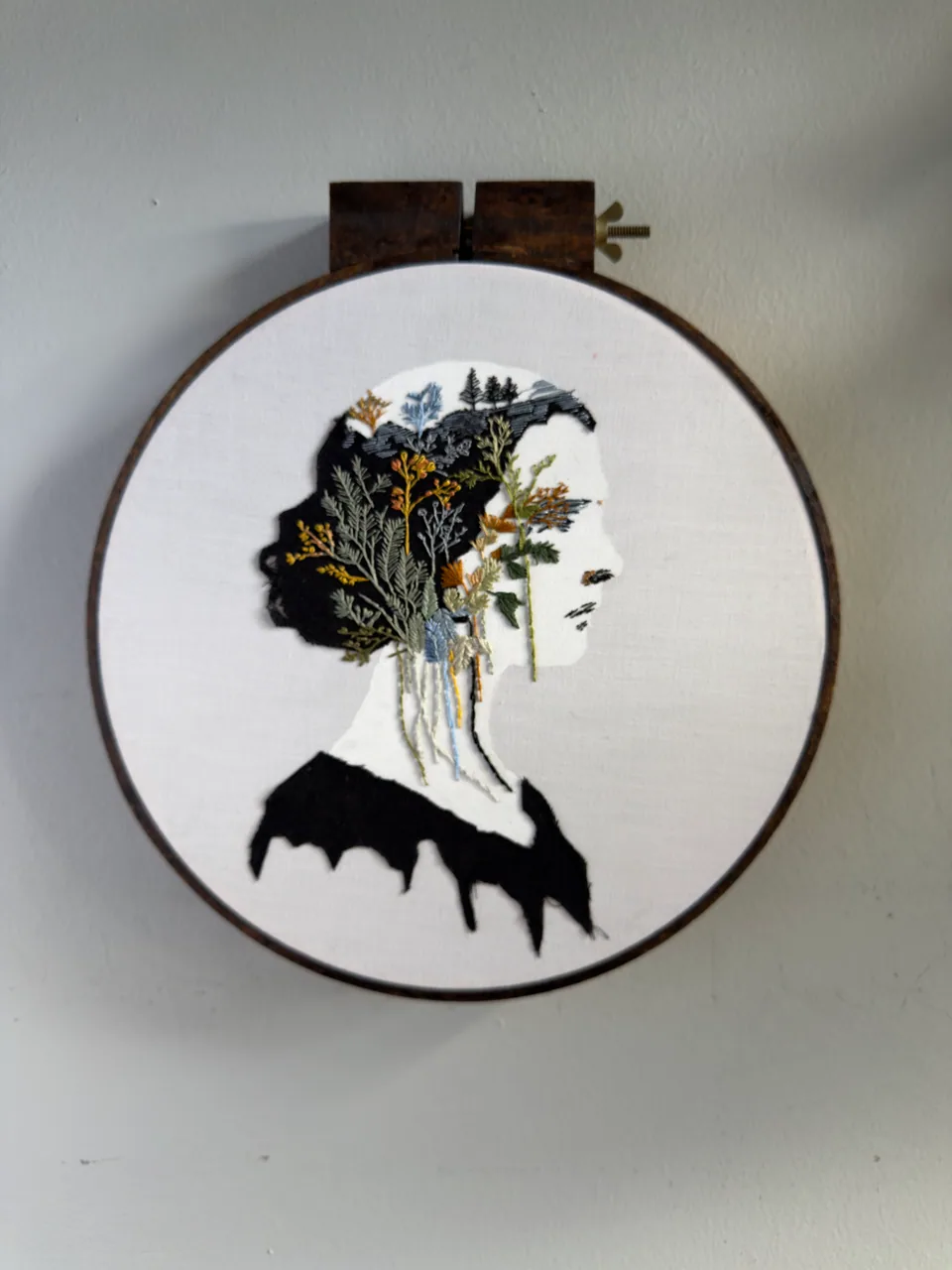 Profile portrait filled with embroidered botanical forms