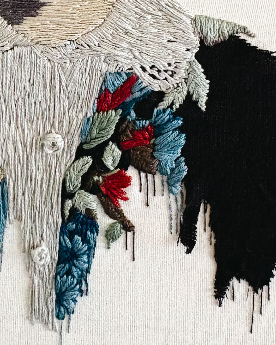Close detail of flowers and trailing stitches