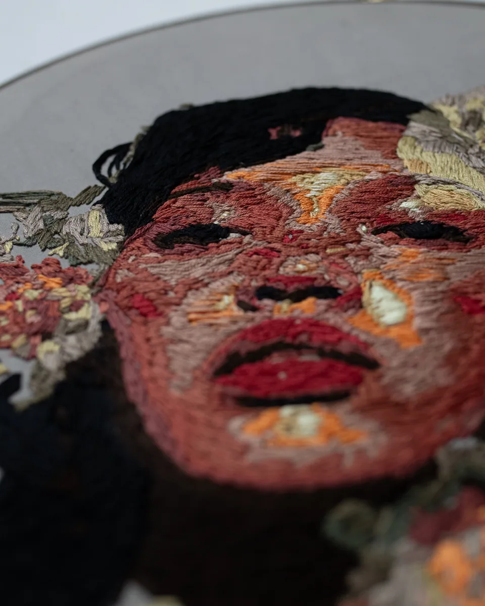 Close detail of the colorful floral portrait embroidery