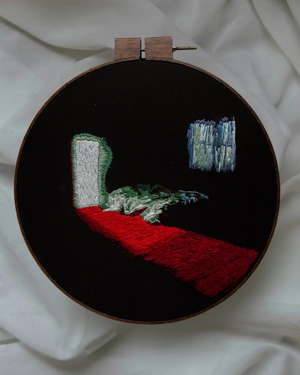 Dark round embroidery with a vivid red path